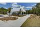 Exterior view of a pool house and pool with a paved walkway, small trees, and green grass at 415 W Respite Ln, Summerville, SC 29483