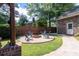 Charming backyard firepit area with Adirondack chairs and stone ground cover at 44 S Basilica Ave, Hanahan, SC 29410