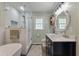 Bright bathroom featuring subway tile shower, soaking tub and double sink vanity at 44 S Basilica Ave, Hanahan, SC 29410
