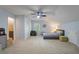 Bright bedroom with a ceiling fan, carpeted floor, and closet space at 44 S Basilica Ave, Hanahan, SC 29410