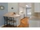 Updated kitchen with white cabinetry, hardwood floors, breakfast bar, and stainless steel appliances at 44 S Basilica Ave, Hanahan, SC 29410