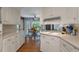 Well-lit kitchen with white cabinets, updated appliances, and hardwood floors at 44 S Basilica Ave, Hanahan, SC 29410