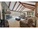 Spacious living room with a brick fireplace, beamed ceilings, and neutral tones throughout at 44 S Basilica Ave, Hanahan, SC 29410