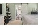 Tastefully decorated primary bedroom with barn door leading to ensuite bath at 44 S Basilica Ave, Hanahan, SC 29410