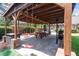 Covered outdoor patio featuring a picnic table, swing, and built-in grill at 44 S Basilica Ave, Hanahan, SC 29410