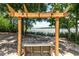 Wooden swing under pergola overlooks a serene body of water at 44 S Basilica Ave, Hanahan, SC 29410