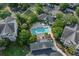 Aerial view of a community pool surrounded by lush greenery, buildings, and parking areas at 45 Sycamore Ave # 611, Charleston, SC 29407