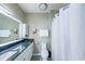Modern bathroom with nice fixtures, white cabinets and a shower with a white curtain at 45 Sycamore Ave # 611, Charleston, SC 29407