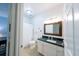 Bright bathroom featuring tiled floors, a granite countertop, and a decorative framed mirror at 45 Sycamore Ave # 611, Charleston, SC 29407