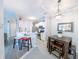 Cozy kitchen and dining area featuring white cabinets, stainless appliances, barstool seating, and modern lighting at 45 Sycamore Ave # 611, Charleston, SC 29407