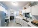 Spacious kitchen with white cabinets, stainless appliances, breakfast bar, and seamless connection to the living area at 45 Sycamore Ave # 611, Charleston, SC 29407