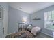 Relaxing living room with grey walls, wood floors, and a variety of fishing poles on display at 45 Sycamore Ave # 611, Charleston, SC 29407