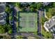 Aerial view of tennis courts situated near parking and surrounded by trees and townhomes at 45 Sycamore Ave # 611, Charleston, SC 29407