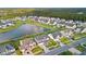 Aerial view of a beautiful neighborhood with a tranquil pond surrounded by lush greenery and well-manicured lawns at 451 Spectrum Rd, Summerville, SC 29486