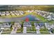 Aerial view of a house in a suburban neighborhood, surrounded by lush trees and a tranquil pond at 451 Spectrum Rd, Summerville, SC 29486