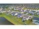 A bird's eye view showing a house near a pond in a residential community with green lawns at 451 Spectrum Rd, Summerville, SC 29486