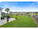 Lush backyard featuring a well-manicured lawn, patio area, and a serene view of the neighborhood pond at 451 Spectrum Rd, Summerville, SC 29486