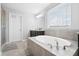 Bright bathroom featuring a soaking tub, vanity with sink, tile floor, and bright natural light at 451 Spectrum Rd, Summerville, SC 29486