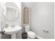 Neutral powder room with pedestal sink and modern fixtures at 451 Spectrum Rd, Summerville, SC 29486