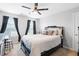 Bedroom with a dark bed frame, white comforter, accent pillows and two windows at 451 Spectrum Rd, Summerville, SC 29486