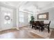 Bright dining room featuring a large dining table, elegant mirror, and a door to the front yard at 451 Spectrum Rd, Summerville, SC 29486
