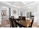Elegant dining room featuring a dark wood table and seating for six, with tray ceiling and crown moulding at 451 Spectrum Rd, Summerville, SC 29486