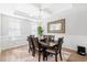 Bright dining room with a large table and chairs, decorative lighting, and tray ceiling at 451 Spectrum Rd, Summerville, SC 29486