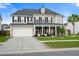 Charming two-story home with neutral siding, black shutters, a two car garage, and a welcoming front porch at 451 Spectrum Rd, Summerville, SC 29486
