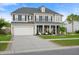Charming two-story home with a well-manicured lawn, a two car garage and inviting front porch at 451 Spectrum Rd, Summerville, SC 29486