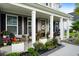 Inviting front porch featuring cozy seating, decorative plants, and a welcoming wreath on the front door at 451 Spectrum Rd, Summerville, SC 29486