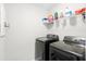 Well-equipped laundry room with modern washer and dryer units and ample storage at 451 Spectrum Rd, Summerville, SC 29486