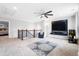 Large living room featuring a mounted television, stylish carpet, and a ceiling fan at 451 Spectrum Rd, Summerville, SC 29486