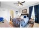 Comfortable main bedroom featuring a ceiling fan, plush bedding, and an ensuite bathroom at 451 Spectrum Rd, Summerville, SC 29486