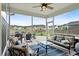 Relaxing screened porch with ceiling fan, plush seating, and an inviting view of the neighborhood at 451 Spectrum Rd, Summerville, SC 29486