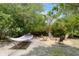 Lush backyard featuring a hammock and fire pit area for relaxation at 4932 N Rhett Ave, North Charleston, SC 29405