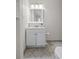 White vanity in bathroom with tiled floor at 4932 N Rhett Ave, North Charleston, SC 29405