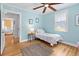 Cozy bedroom with light blue walls, hardwood floors, and natural light at 4932 N Rhett Ave, North Charleston, SC 29405