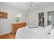 Comfortable bedroom with wood floors, a closet, a dresser, and a view to the outdoors at 4932 N Rhett Ave, North Charleston, SC 29405