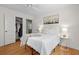Inviting bedroom with white walls, a ceiling fan, neutral bedding, wood floors, and a closet at 4932 N Rhett Ave, North Charleston, SC 29405