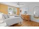 Bright bedroom featuring a large window, a comfy bed, wood floors, and a view to the outdoors at 4932 N Rhett Ave, North Charleston, SC 29405