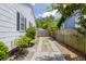 Long, private driveway with a fenced yard and lush greenery surrounding the property at 4932 N Rhett Ave, North Charleston, SC 29405