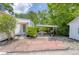 Charming home exterior with a brick driveway, landscaped yard, and covered patio with a grill at 4932 N Rhett Ave, North Charleston, SC 29405