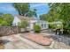 Charming home with brick driveway, fenced yard, well-maintained landscaping, and an outdoor grill at 4932 N Rhett Ave, North Charleston, SC 29405