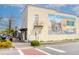Charming building exterior with a mural, pedestrian walkway, and street parking at 4932 N Rhett Ave, North Charleston, SC 29405
