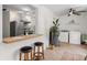 Functional laundry area with tile floors, stainless steel refrigerator, and access to the bright, plant-filled kitchen at 4932 N Rhett Ave, North Charleston, SC 29405
