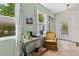 Relaxing sunroom featuring large windows, tile floors, eclectic decor and a view to the outdoors at 4932 N Rhett Ave, North Charleston, SC 29405