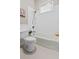 White bathroom with subway tile, neutral walls, bathtub with shower, and traditional fixtures at 5 1/2 Kracke St # A, Charleston, SC 29403