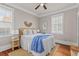 Charming bedroom with white bedding, hardwood floors, and sun-filled windows at 5 1/2 Kracke St # A, Charleston, SC 29403