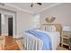 Cozy bedroom featuring hardwood floors, neutral walls, and a comfortable bed at 5 1/2 Kracke St # A, Charleston, SC 29403