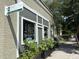 Exterior view of Pinot + Provisions Wine and Market, with potted plants enhancing the sidewalk appeal at 5 1/2 Kracke St # A, Charleston, SC 29403